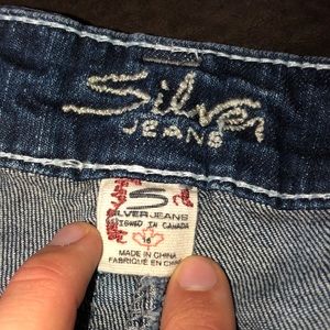 Ripped boot cut silver jeans